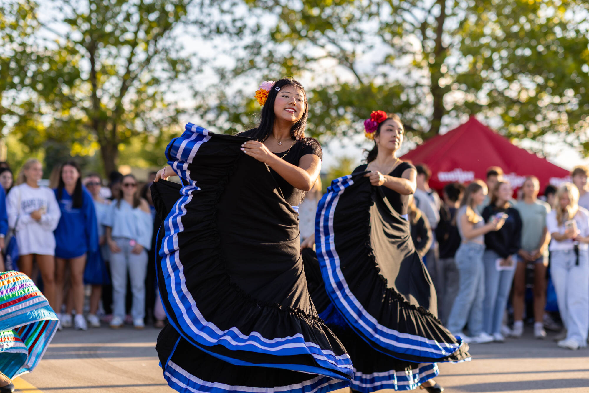 Students wearing long flowy dresses dancing at Campus Life Night